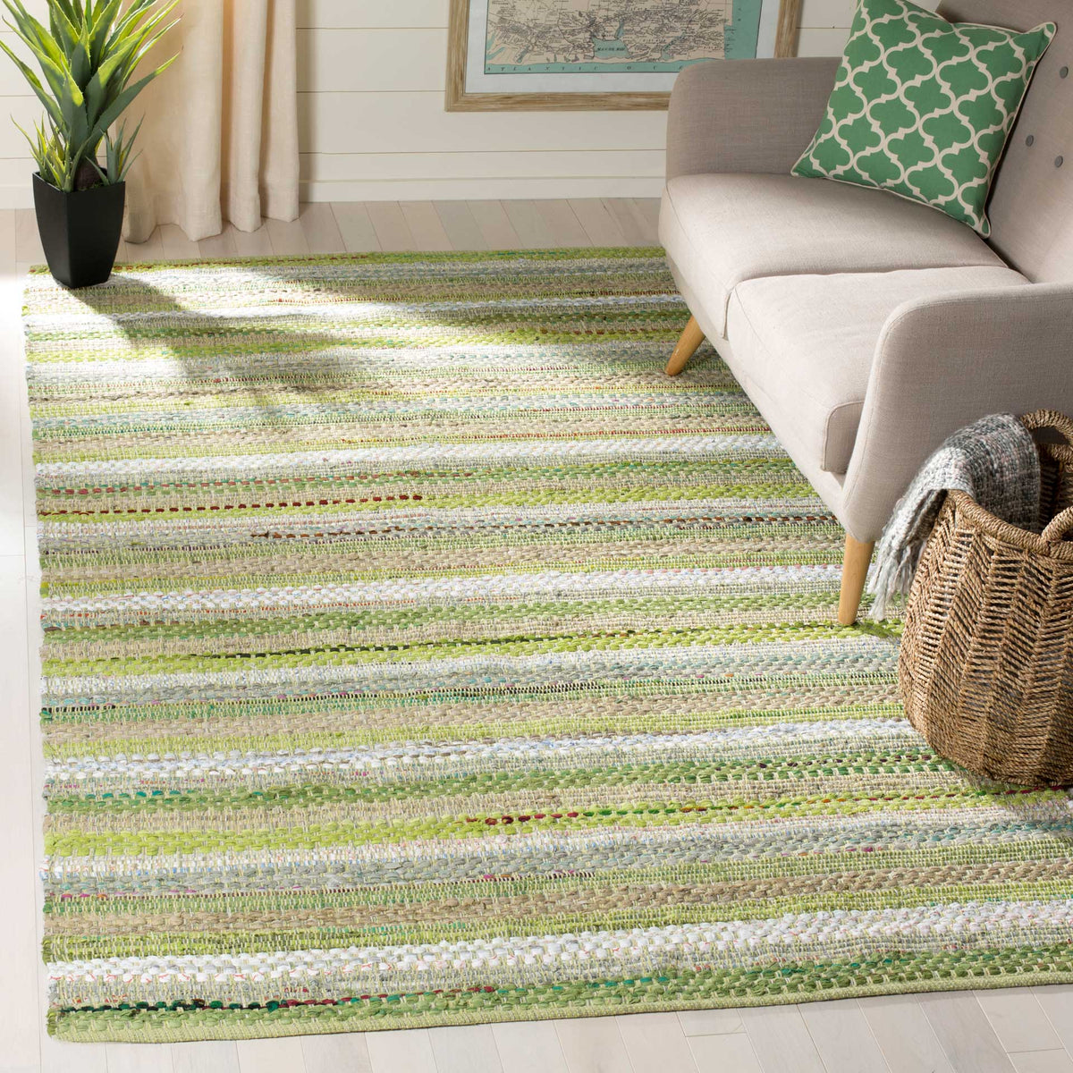 Fresh green and ivory cotton stripes lend a lively, textured feel to a cozy seating area.