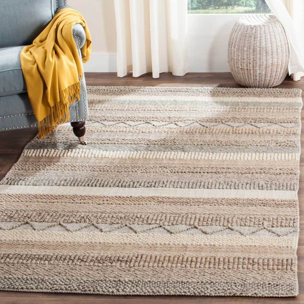 A beige and ivory striped rug adds tactile geometric detail and warmth to a relaxed living room.