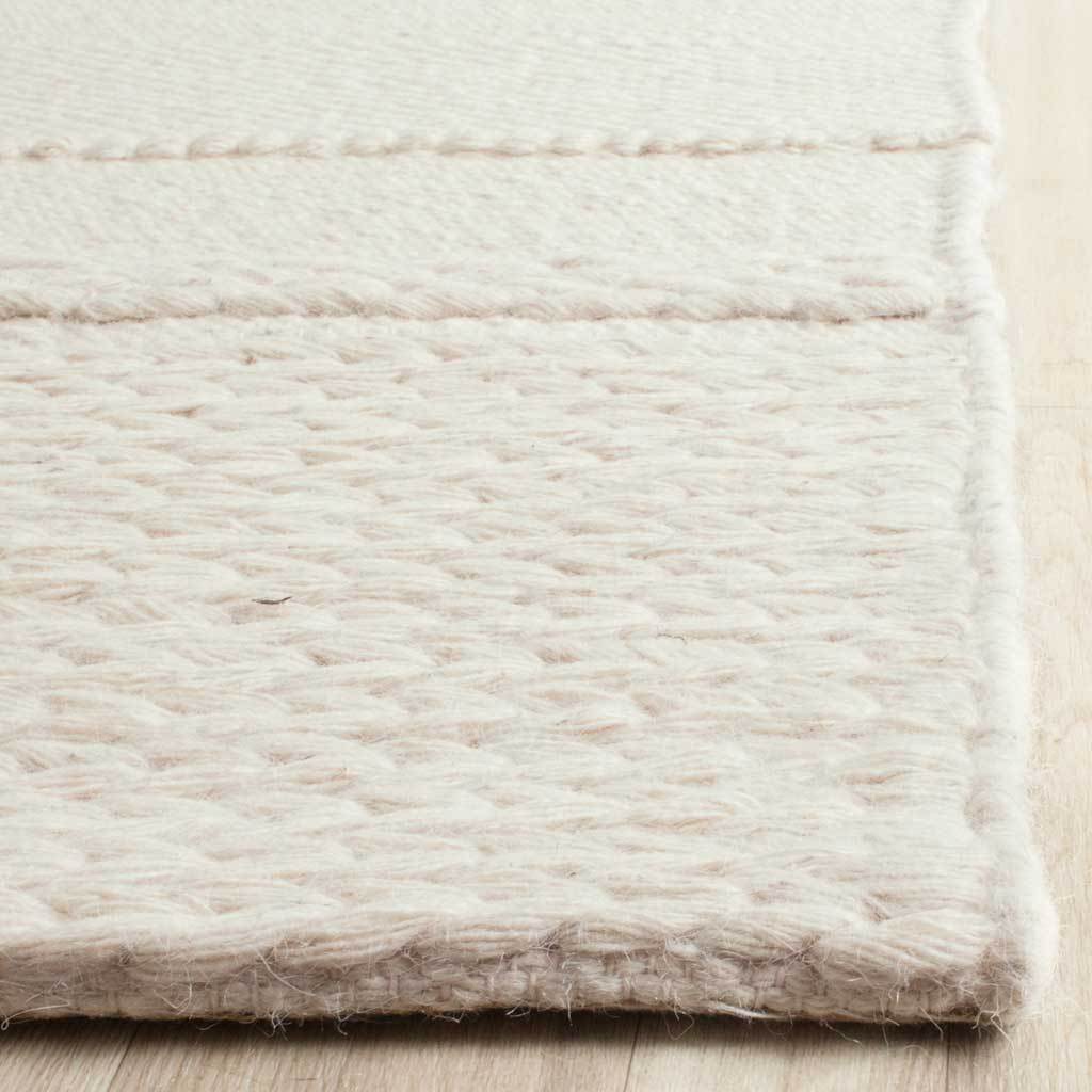Chunky woven rows and a neatly finished edge add tactile warmth to this ivory rug.
