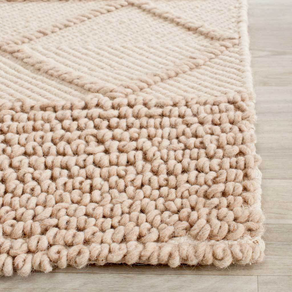 Plush wool-cotton loops and raised diamond lines highlight the rug's textured edge