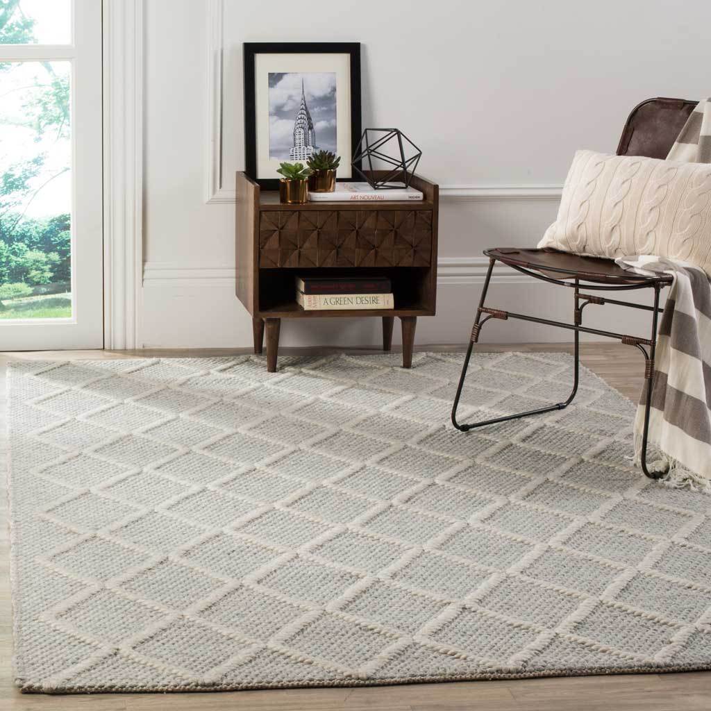 An ivory diamond lattice brings airy pattern to the silver rug beneath a seating area.