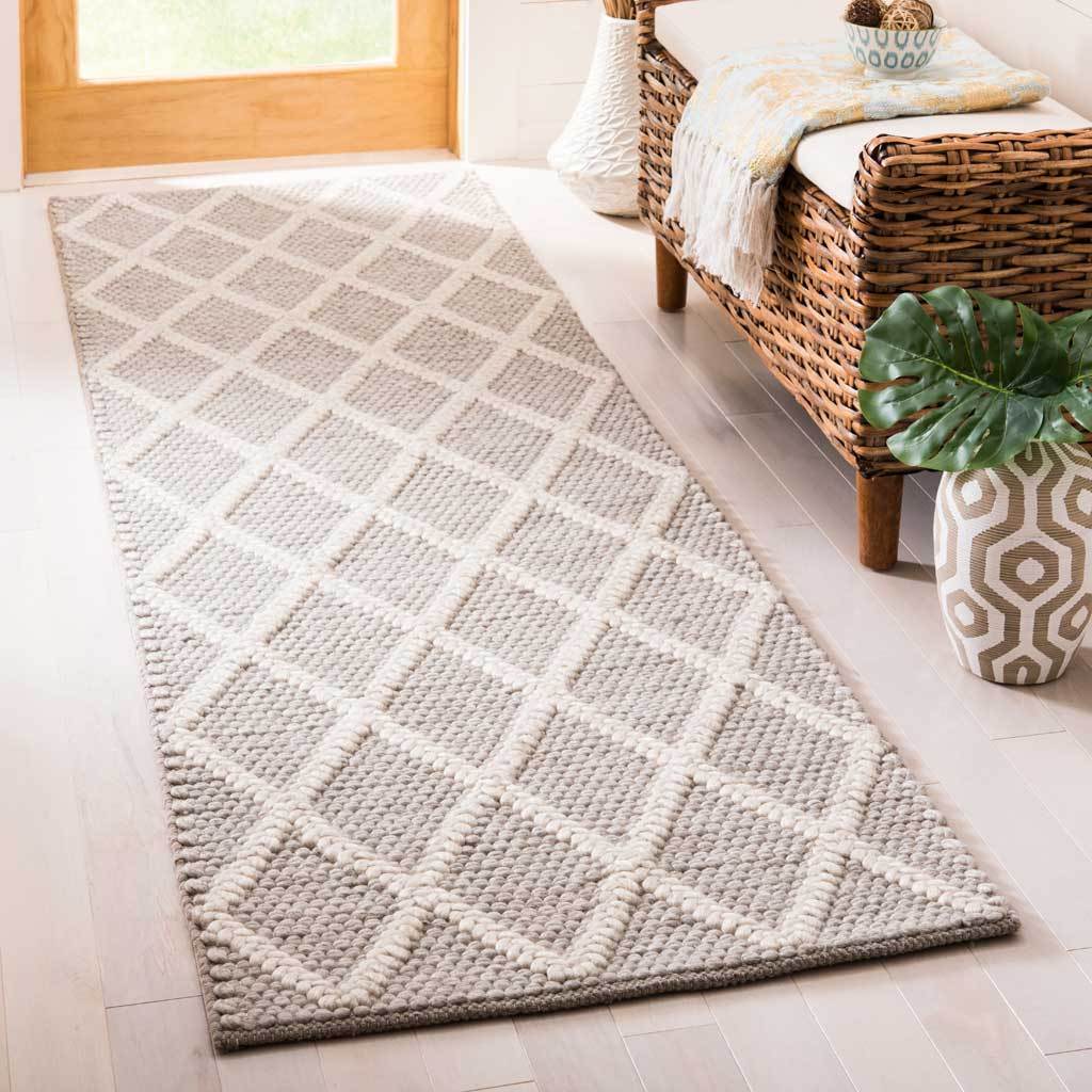 Gray and ivory runner with plush diamond lines that add texture beside a woven bench