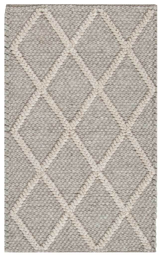 Chunky gray weave and raised ivory diamonds give this accent rug inviting texture.