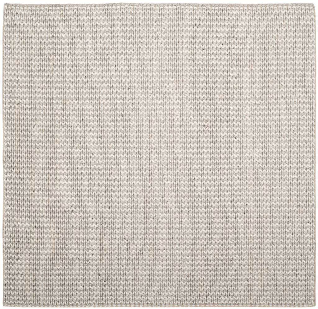 A square ivory and silver rug adds gentle texture with its tonal weave.