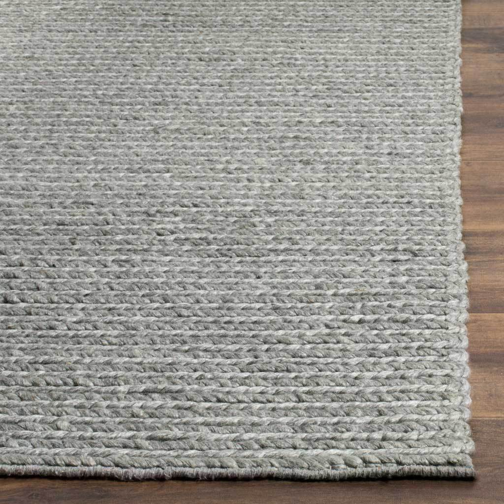 Raised rows of steel gray yarn meet neatly bound edges for a tactile finish.