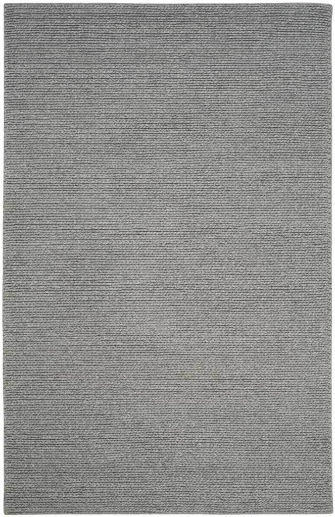 A steel gray rectangular rug adds quiet dimension with its closely woven texture.