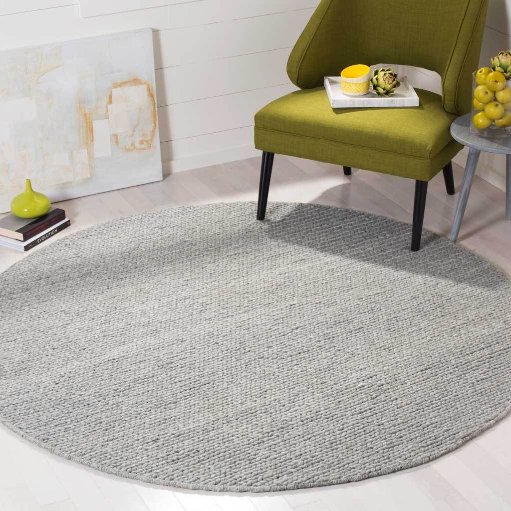 Textured steel-gray round rug anchors a contemporary seating area