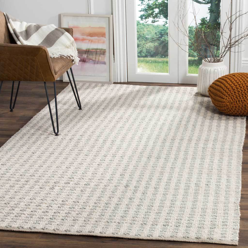 Subtle gray and ivory stripes bring welcoming texture to a bright, contemporary living room