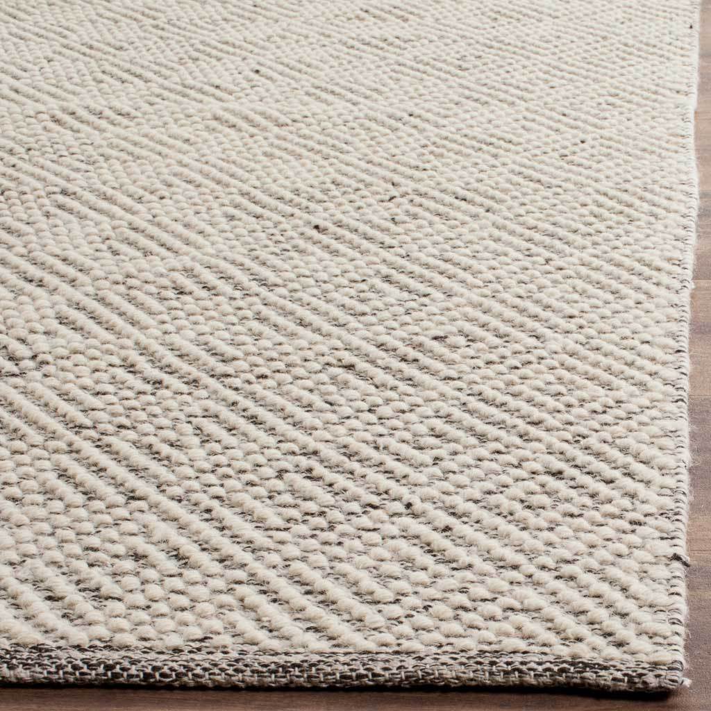 Raised ivory loops trace a subtle diamond motif beside a neatly finished edge.