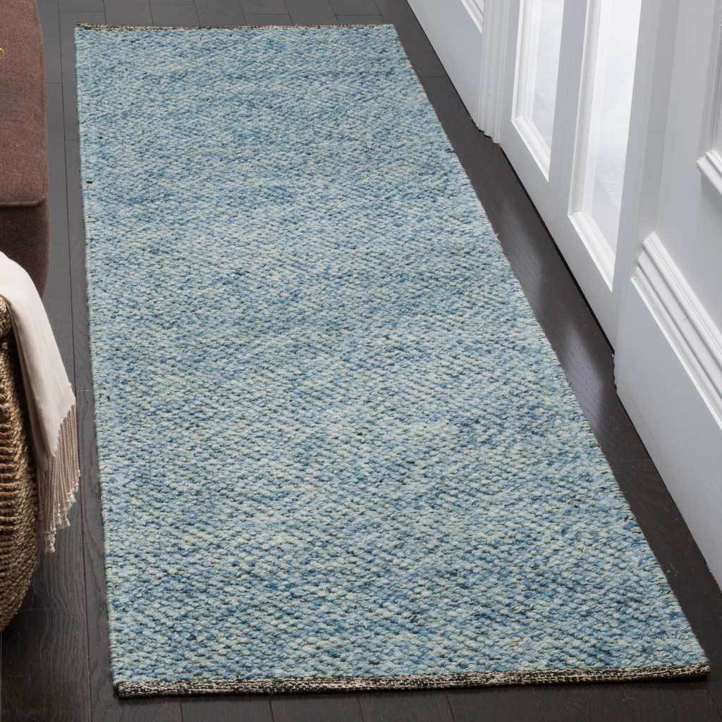 A textured blue runner brings a calm touch of color to a narrow hallway