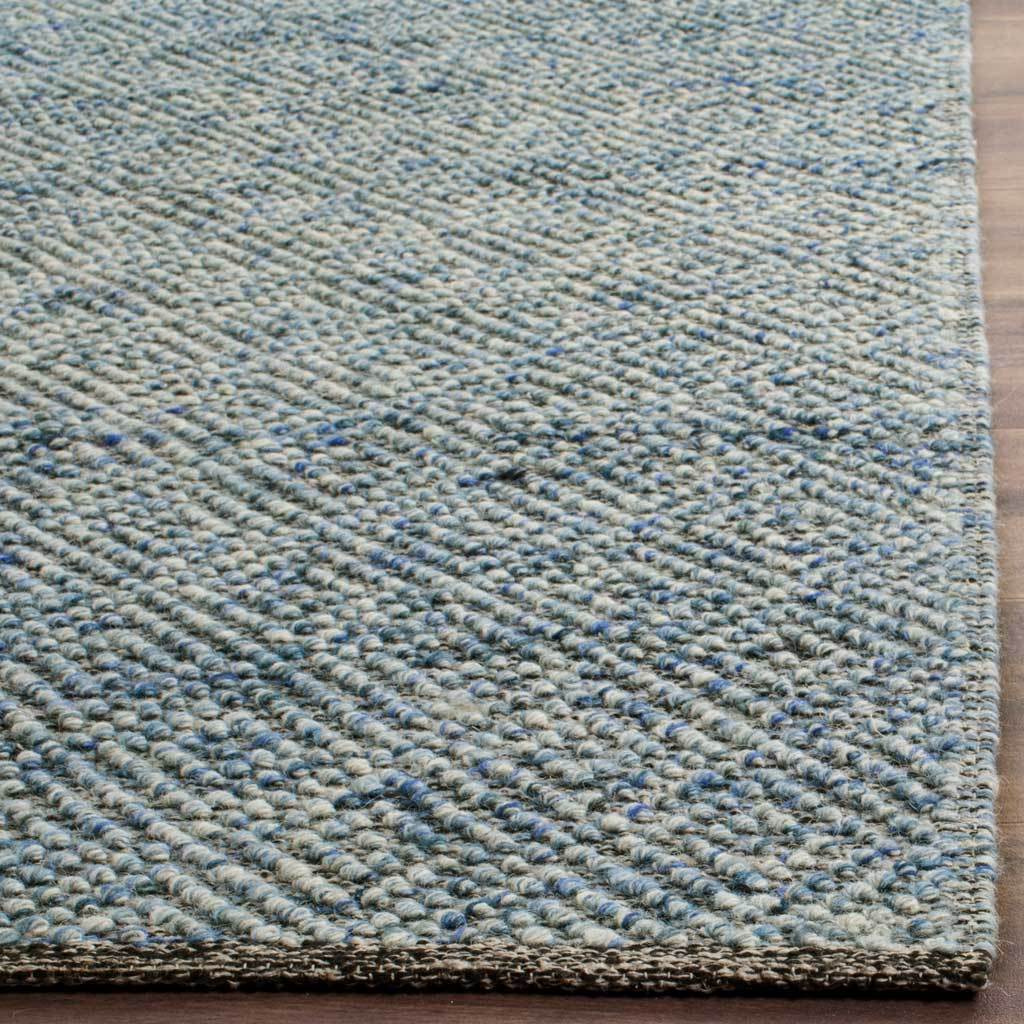 Plush blue-and-cream loops and a neat bound edge showcase the rug's tactile weave.