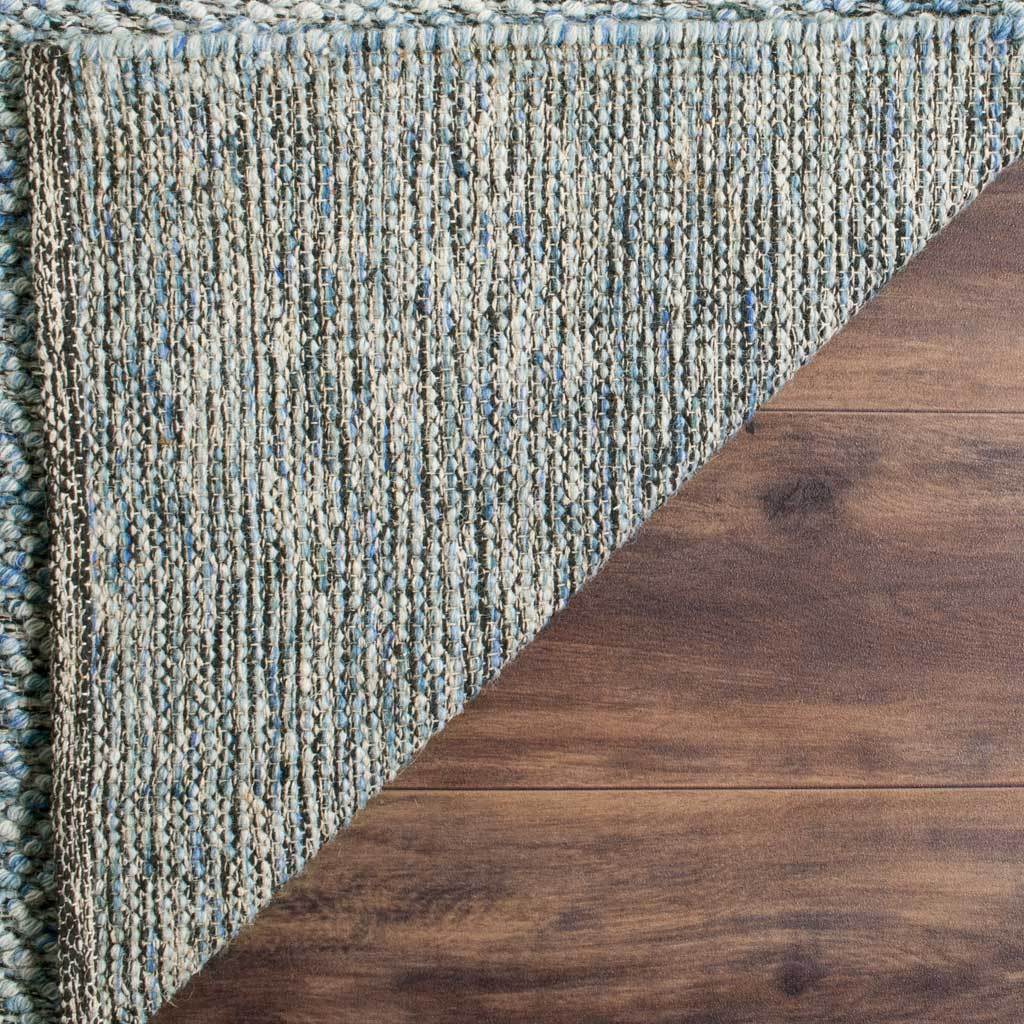 A tightly woven, striped underside meets a sturdy edge on this blue wool-cotton rug.
