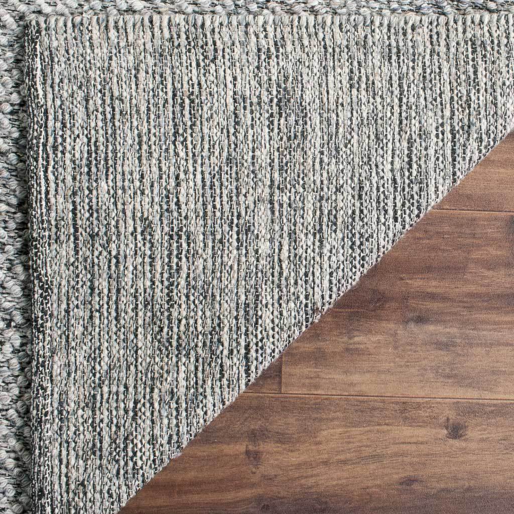Gray and camel strands form a finely striped backing with a neatly finished edge.