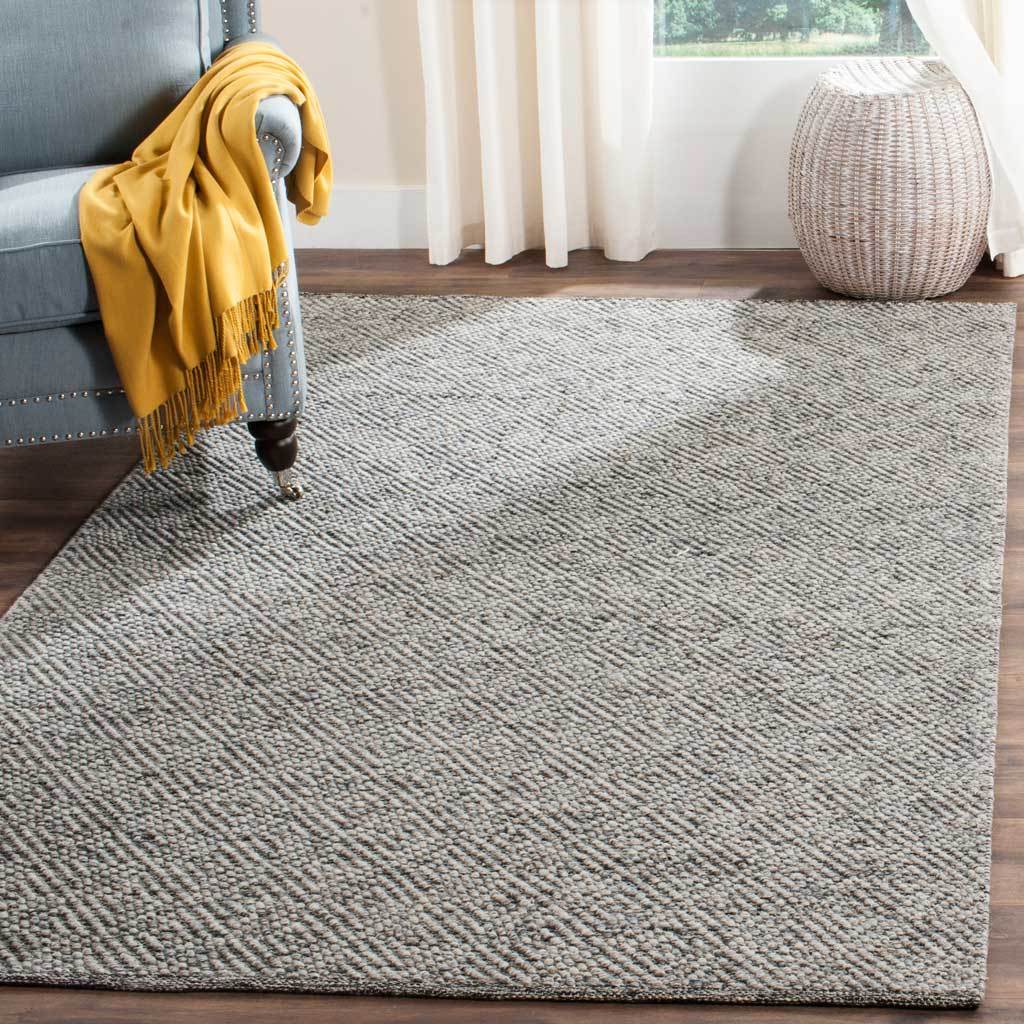 A camel and gray rug lends a serene, textured foundation to a bright living area.