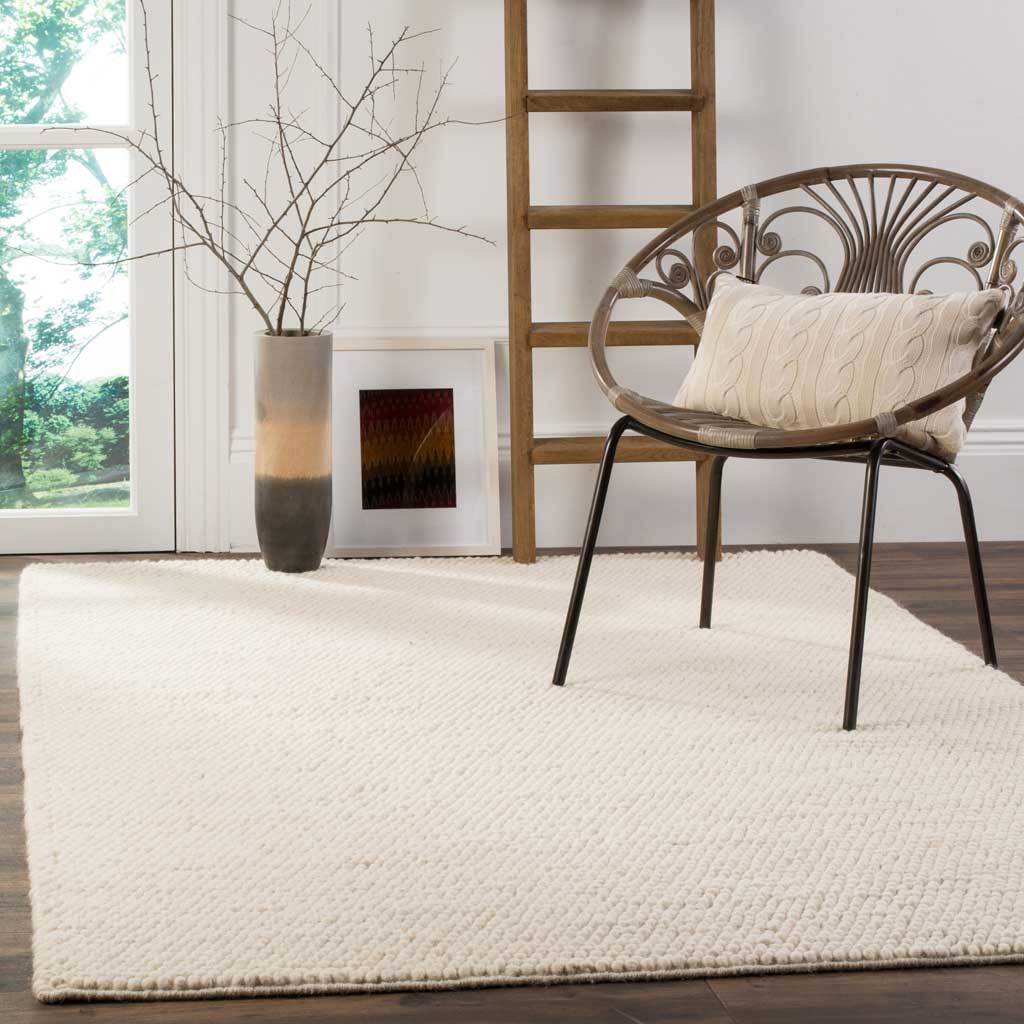 A soft ivory rug brightens a seating nook with cozy, pebble-like texture