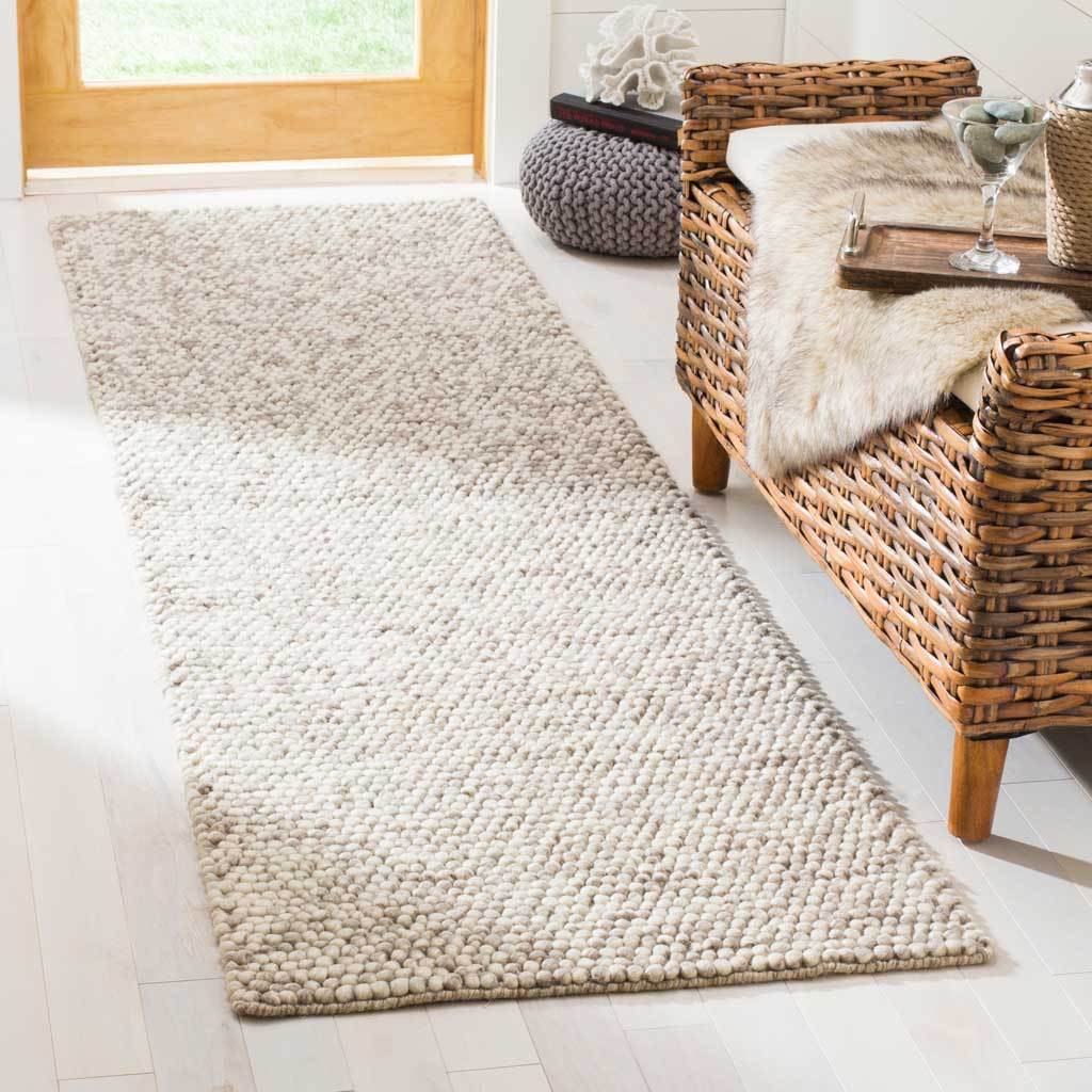 Beige runner brings cozy texture to a bright space beside a woven chair