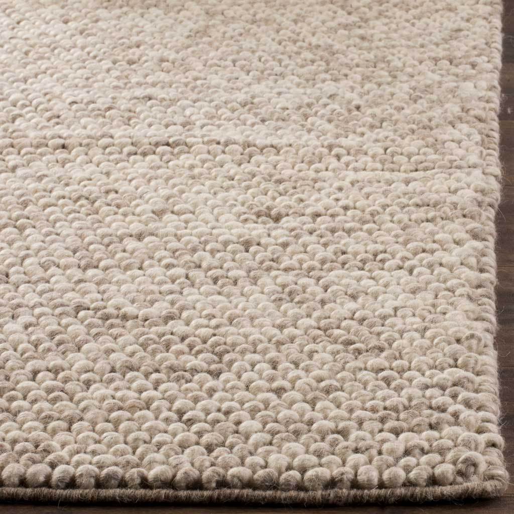Rounded beige loops create tactile depth along the rug's neatly finished edges