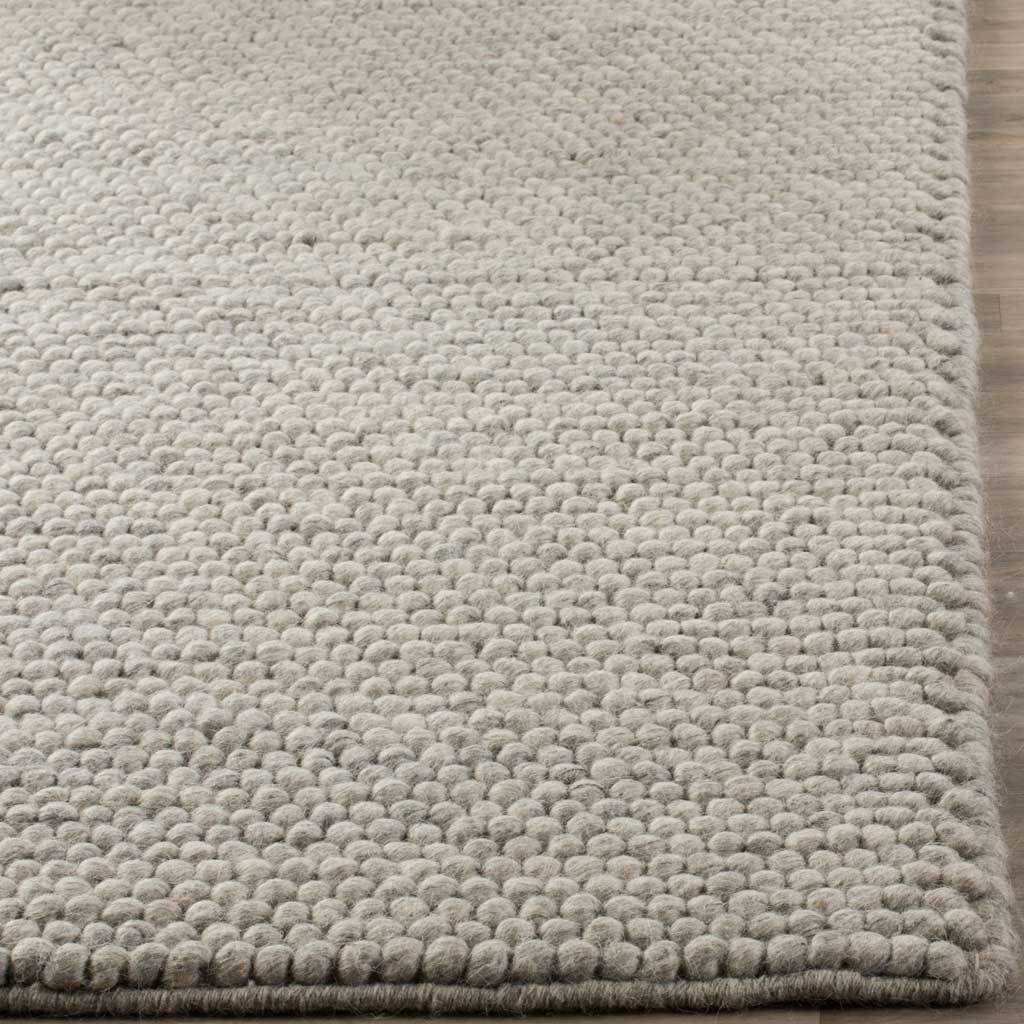 Silver-gray loops cluster along the bound rug edge for soft, tactile appeal