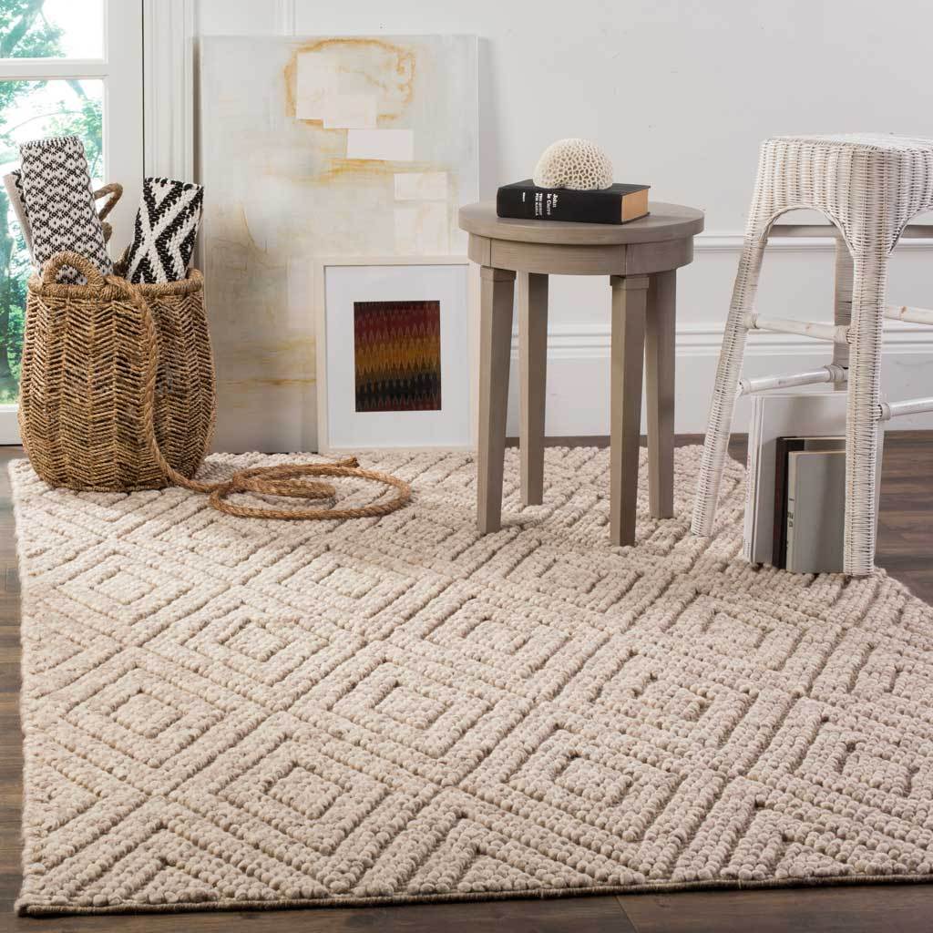 Raised diamond motifs lend inviting texture to this beige rug in a bright living space
