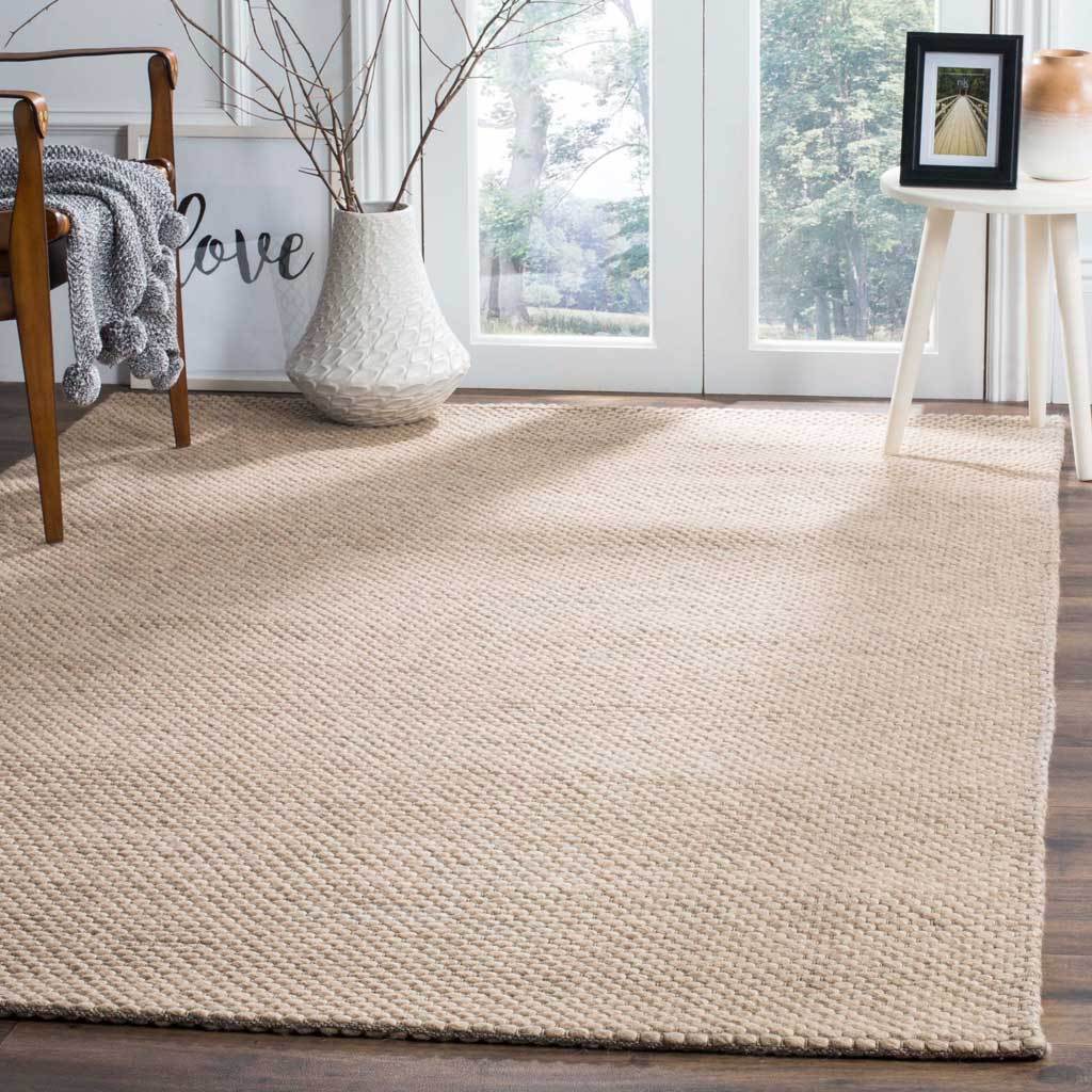 A warm beige rug lends inviting handwoven texture to a bright living space.