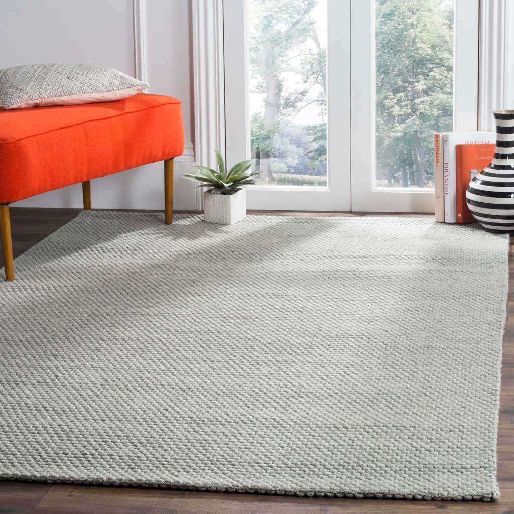 A textured gray rug adds a calm foundation beneath vibrant furnishings.