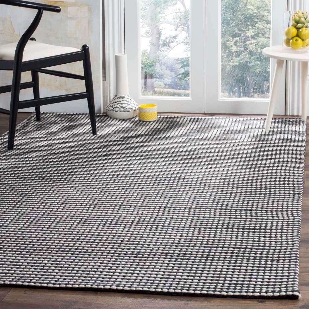 Ivory and black woven stripes lend graphic contrast to a light-filled room.