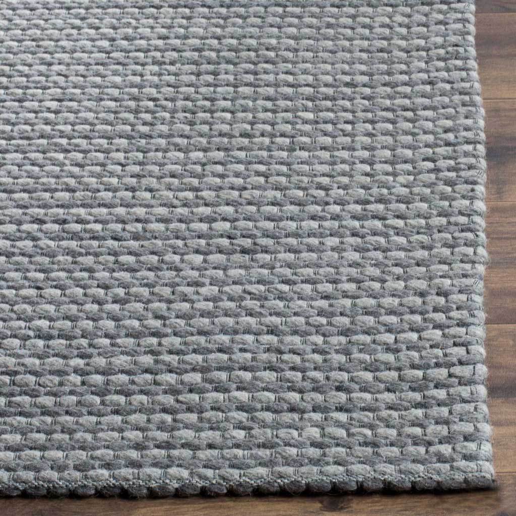 Thick gray loops showcase the rug's tactile weave and neatly finished corner.
