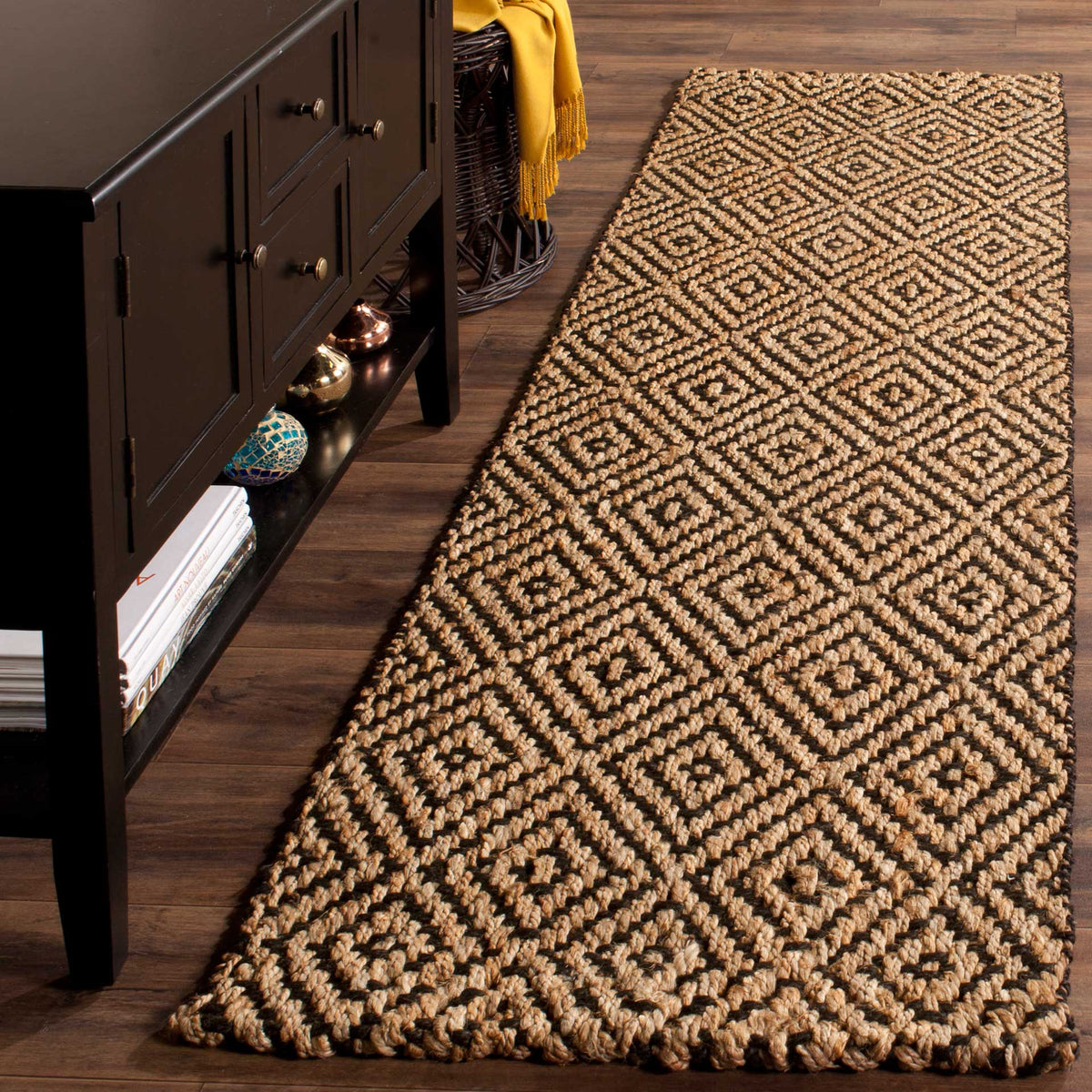Striking black diamonds contrast with golden jute to bring graphic warmth to a wood-floored room.