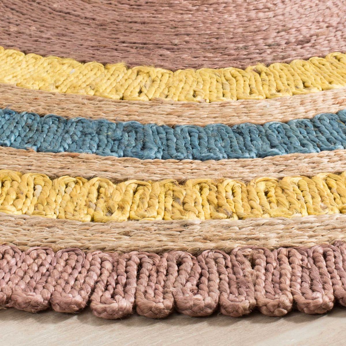 Tactile lavender, blue, and yellow loops alternate with natural braided jute rings.