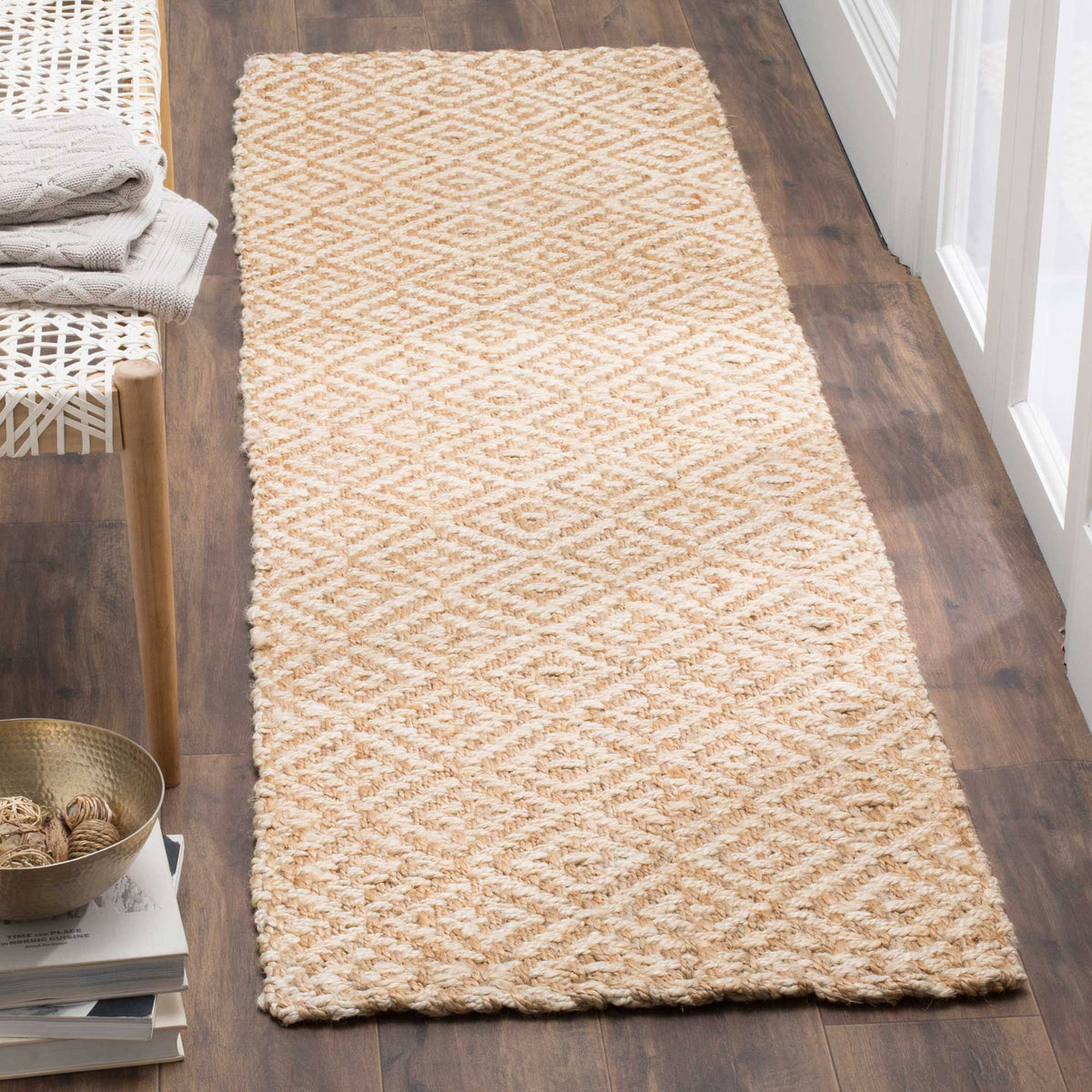 Creamy ivory and tan diamonds add soft geometric texture to a wood-floored hallway.