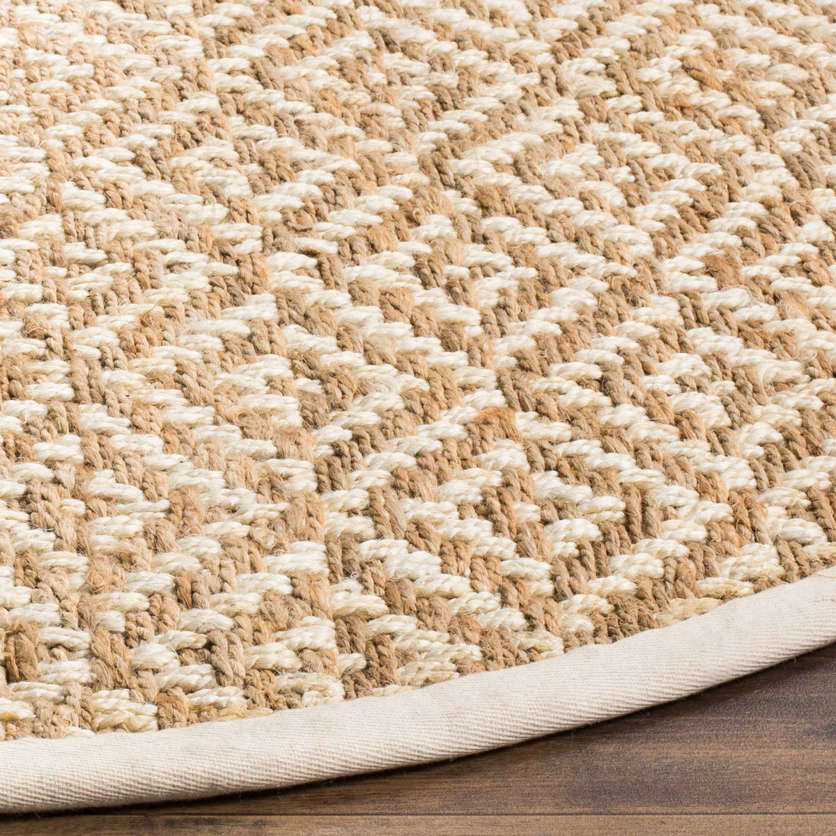 Raised ivory stitching defines a natural jute diamond pattern above a pale fabric border.