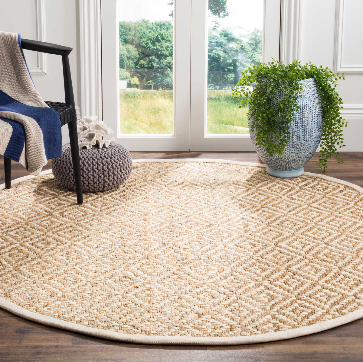 A textured ivory diamond motif brightens the natural woven surface of this round jute rug.
