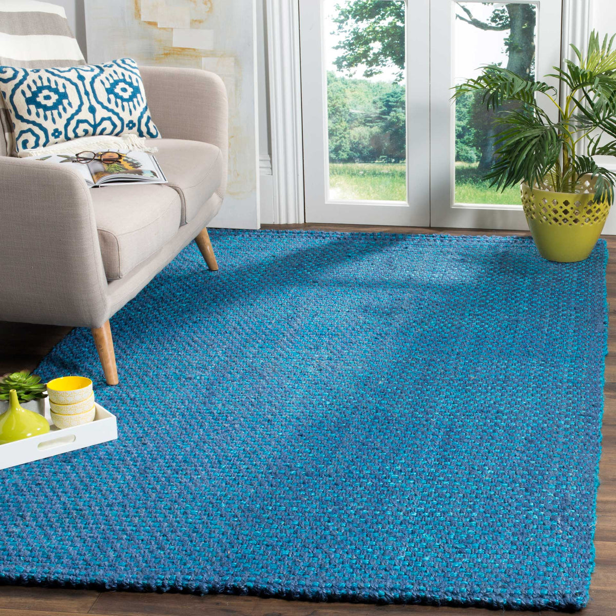 Vivid blue jute rug grounds a light sofa with a lively, textured weave.