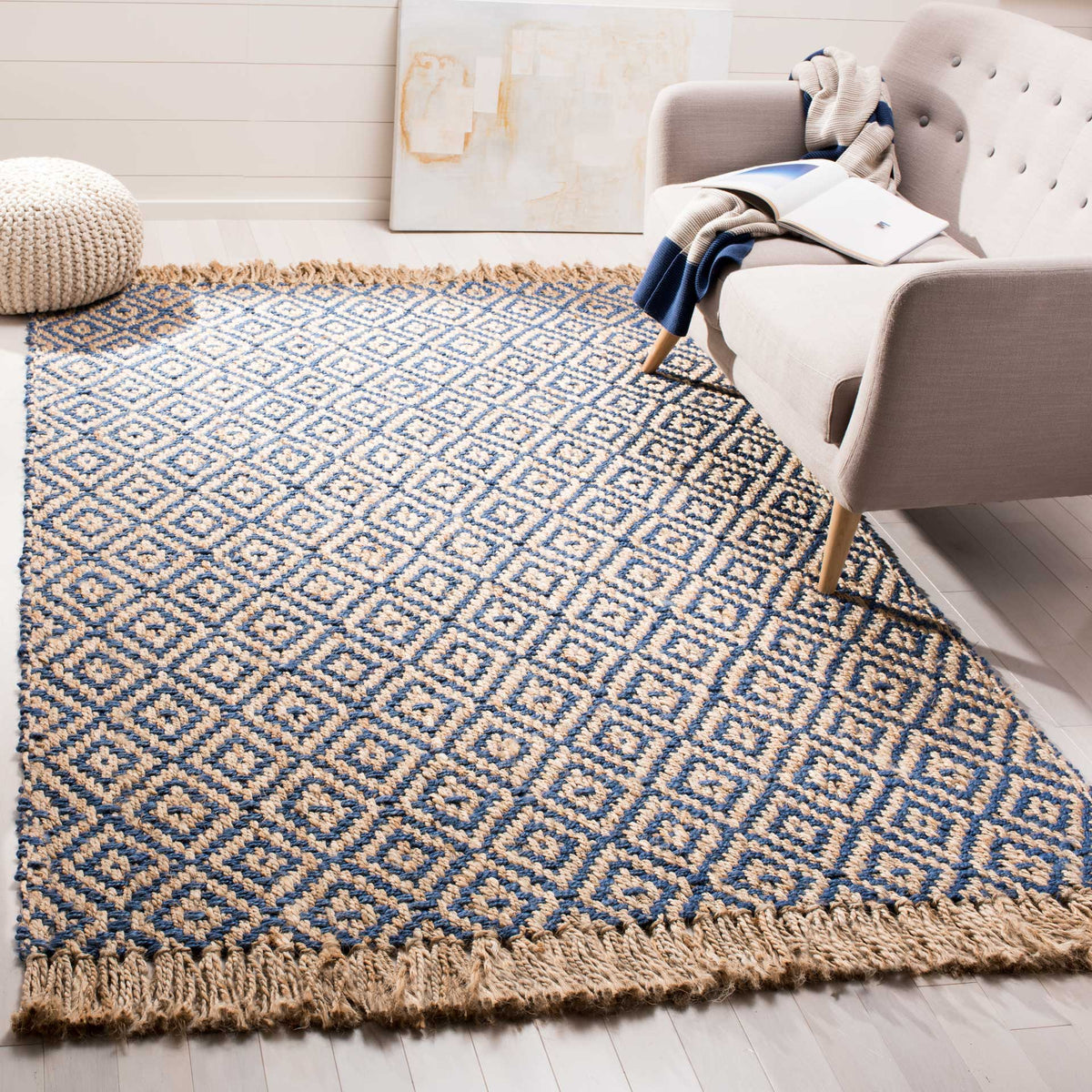 A blue-and-natural diamond jute rug brings graphic texture beneath a light sofa.