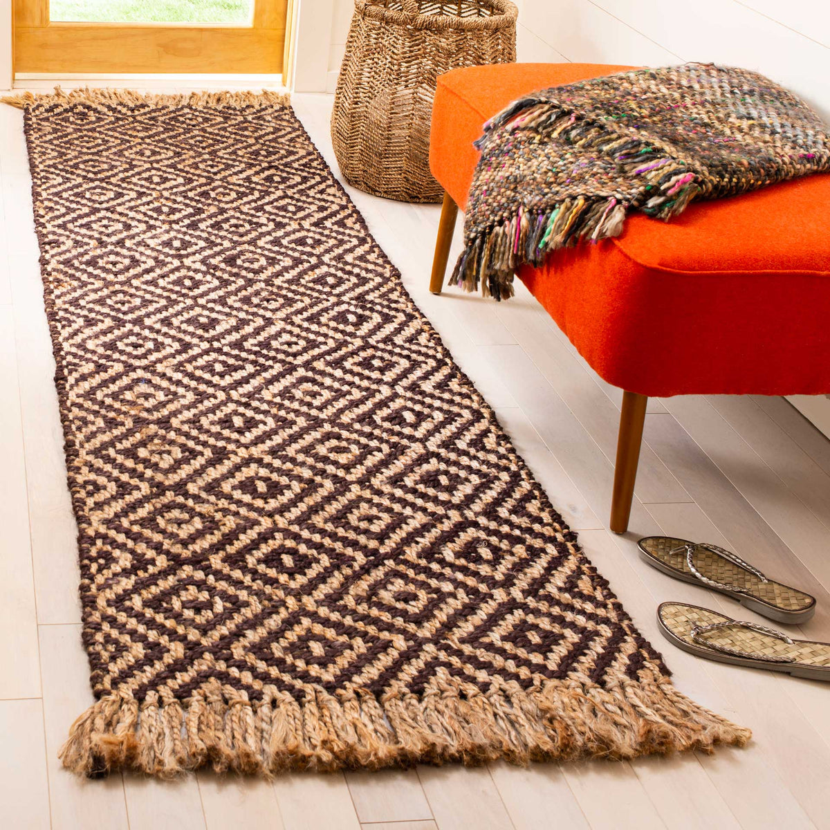 Bold brown diamonds and natural fringe bring earthy character to a bright entryway.