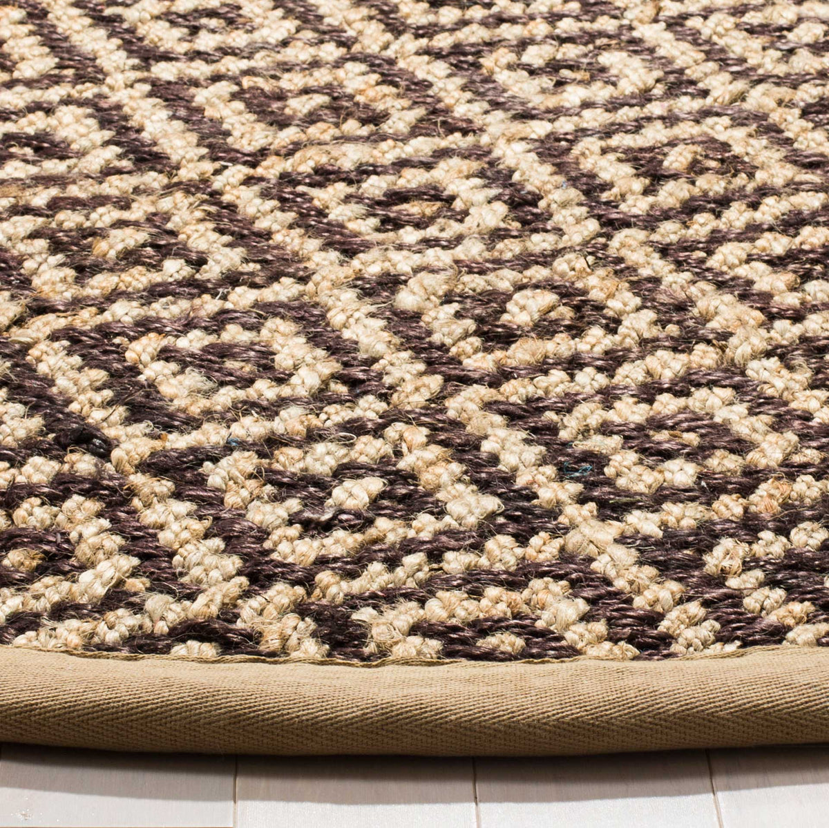 Raised brown and natural diamond weaves meet a smooth tan fabric-bound edge.