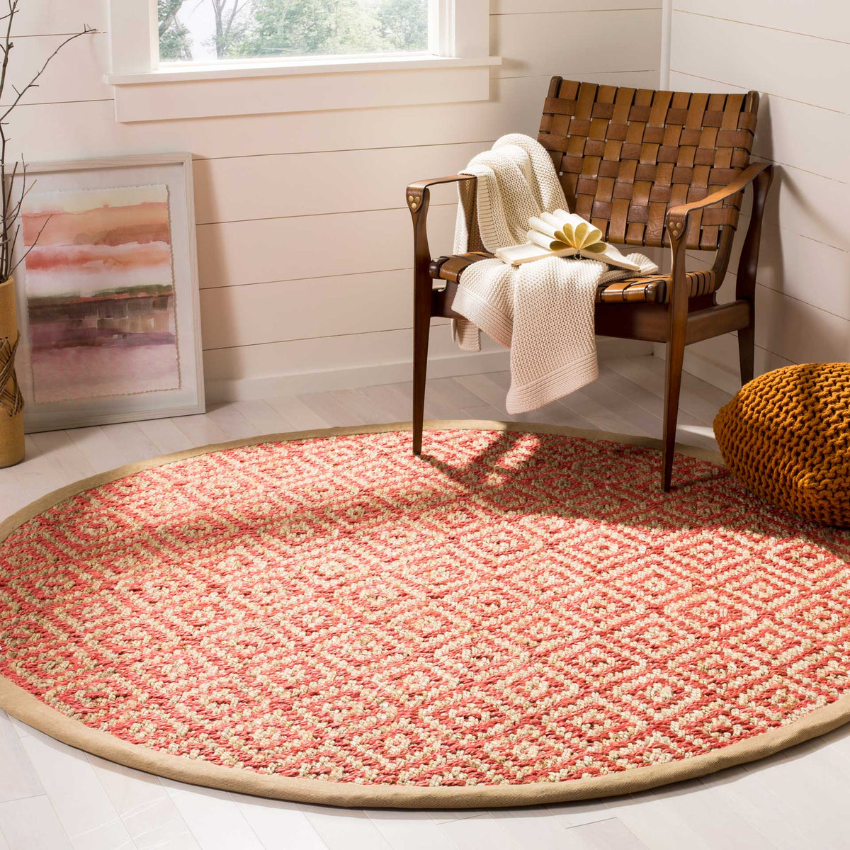 Vibrant coral-pink diamonds energize this woven jute rug's earthy natural base.