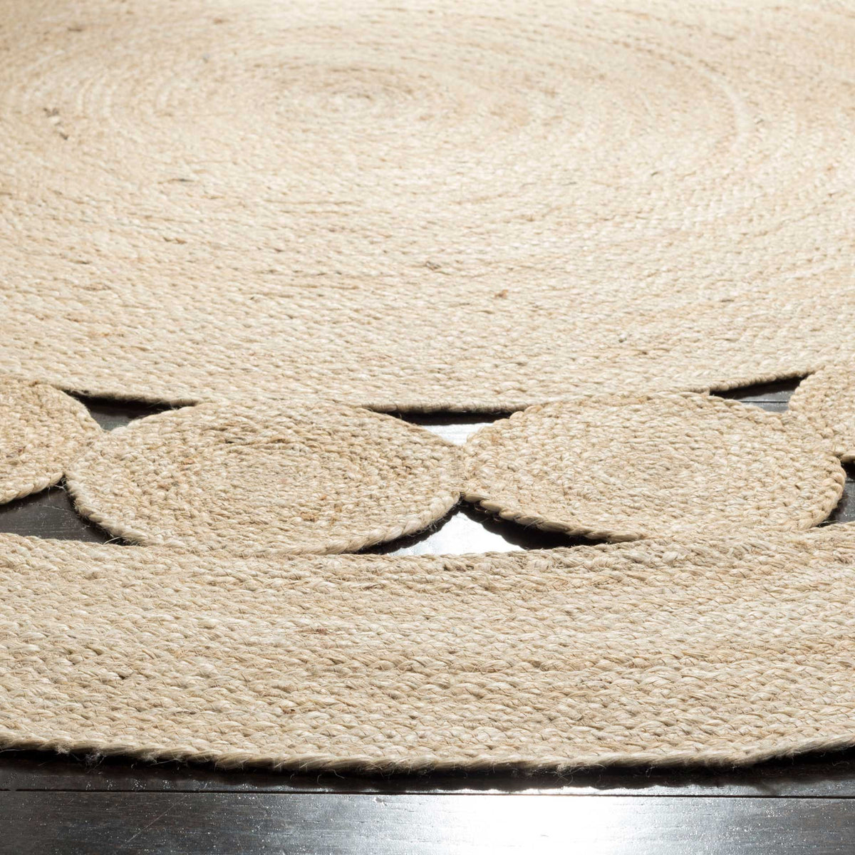 Ivory jute discs bridge open spaces between tightly coiled inner and outer bands.
