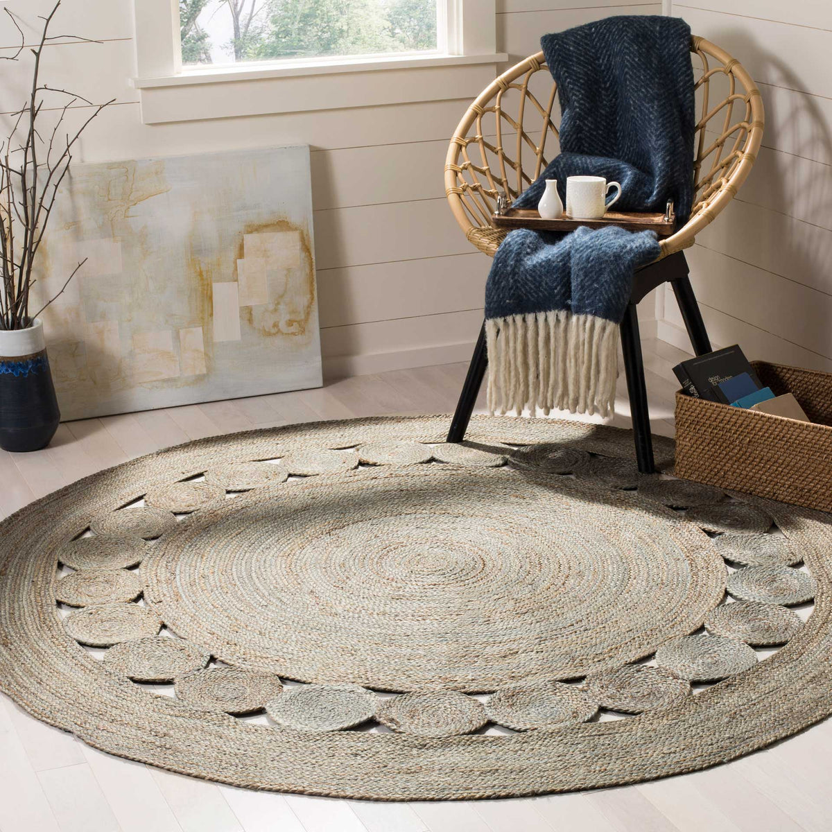 Coiled gray jute and a ring of openwork medallions add soft, sculptural floor texture.