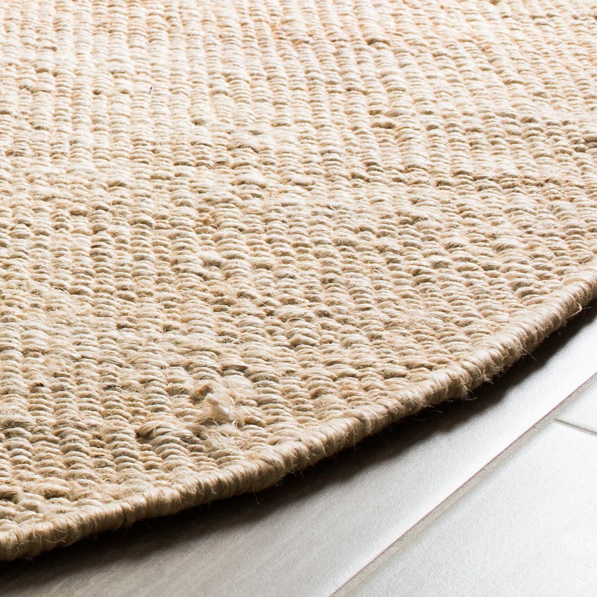 Creamy jute loops and a closely woven edge give this rug an inviting natural texture.