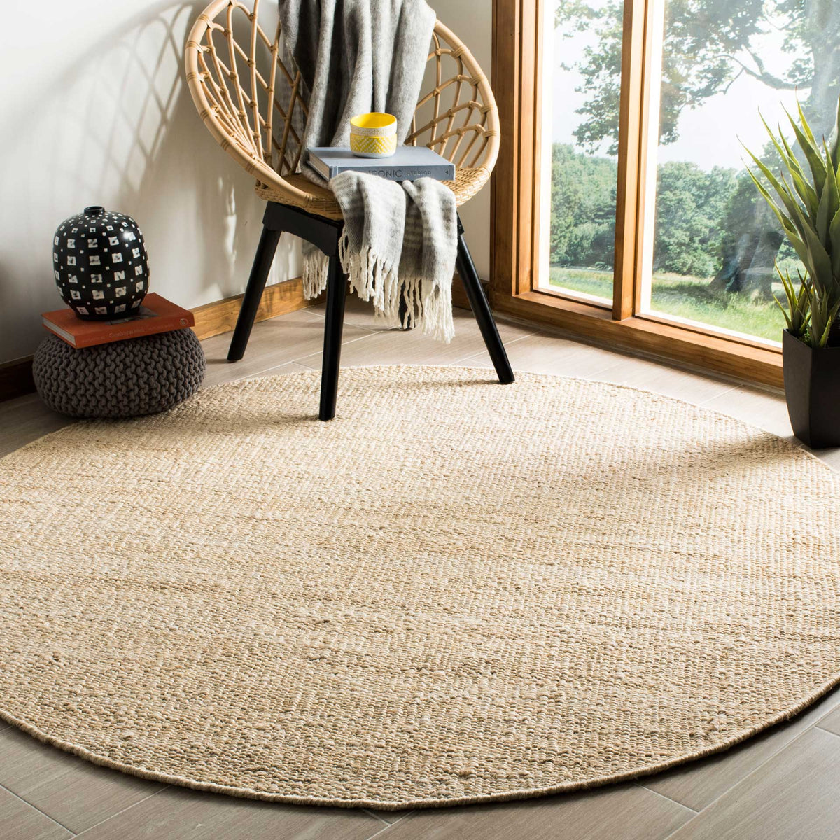 A pale ivory weave adds cozy natural texture to this serene round rug.