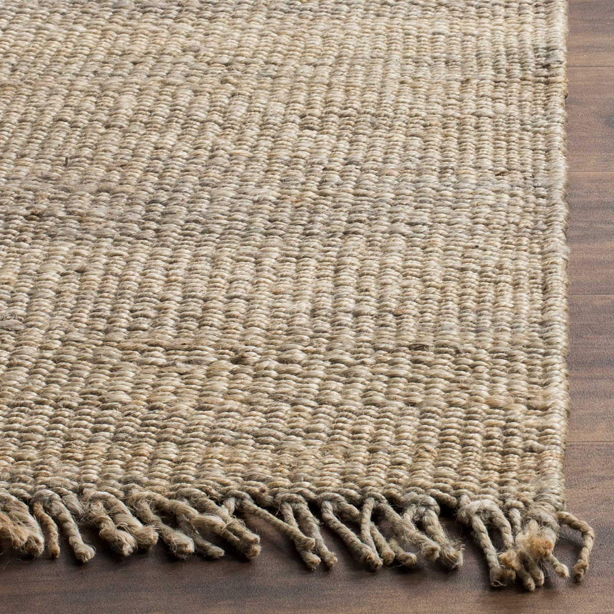 Gray and natural jute strands meet at a textured corner with loose fringe.