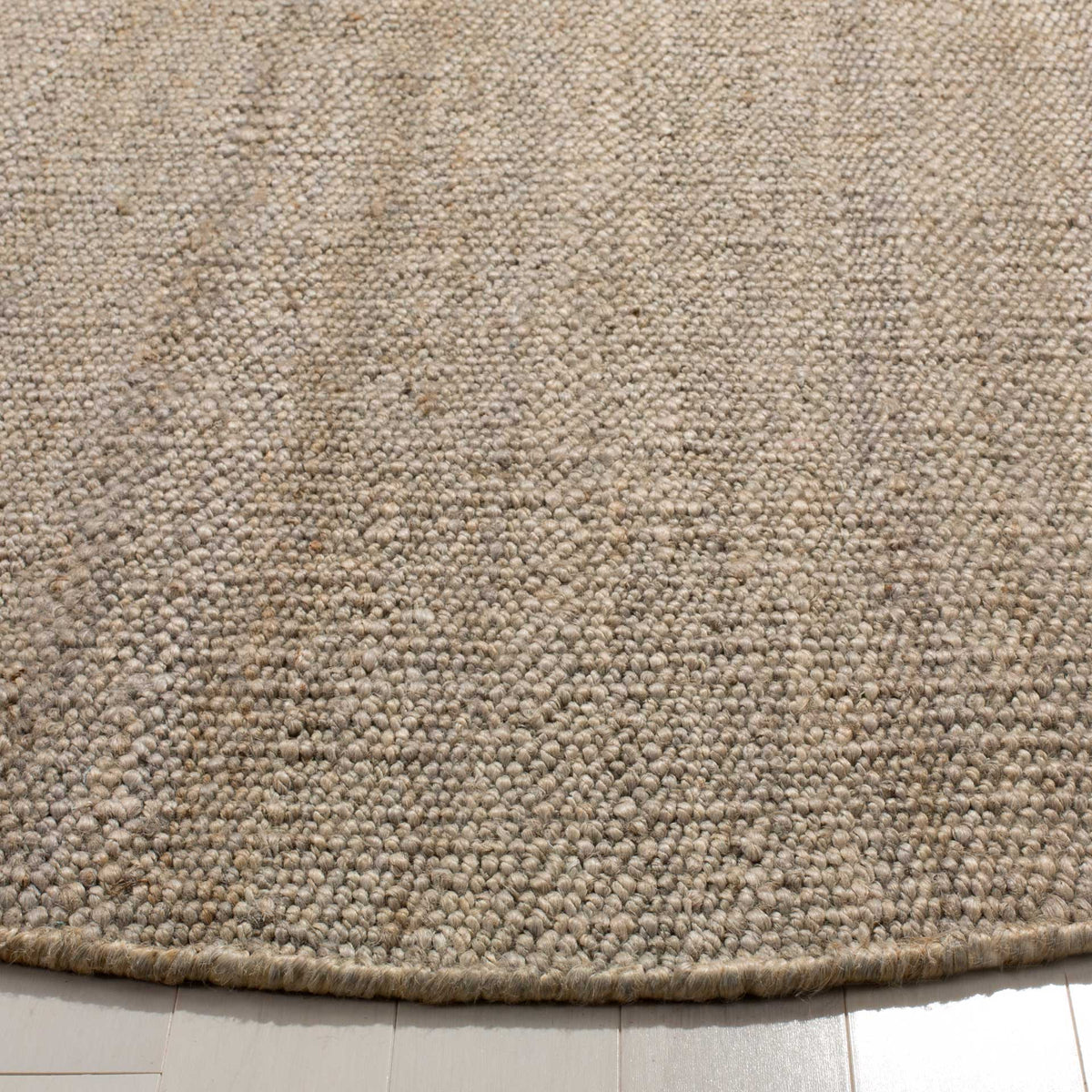 Tightly woven gray jute fibers and a neat rounded edge highlight its natural texture.
