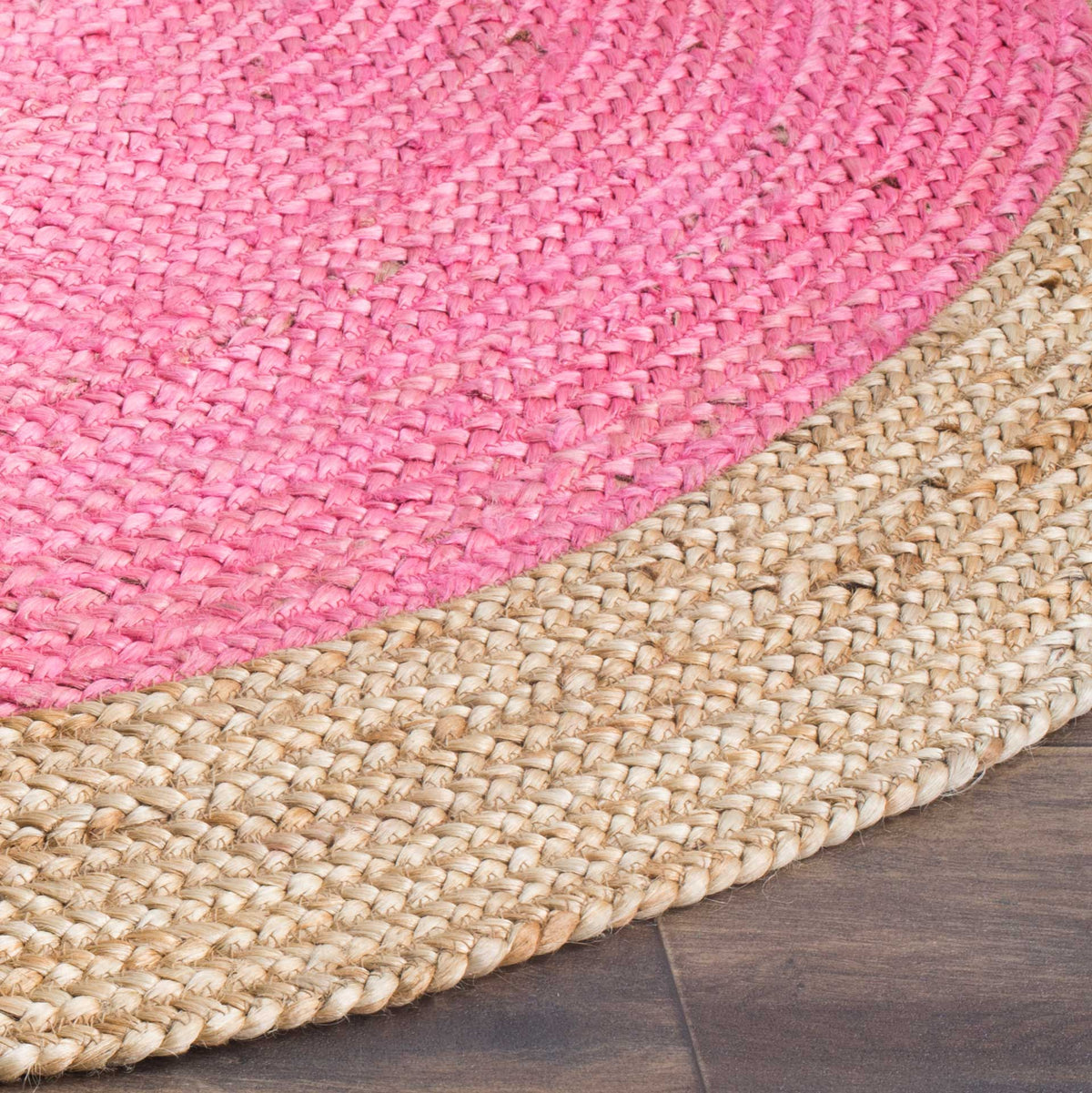Bright pink woven coils flow into the thicker natural jute border along the curved edge.