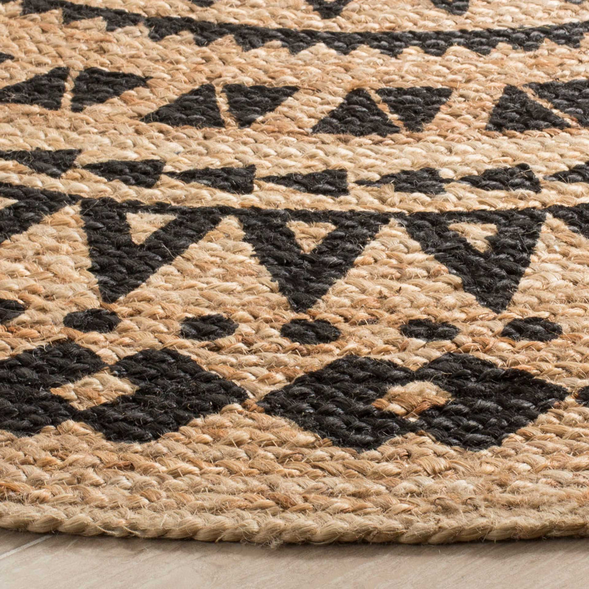 Bold black triangles stand out on textured natural jute above a firmly woven edge.