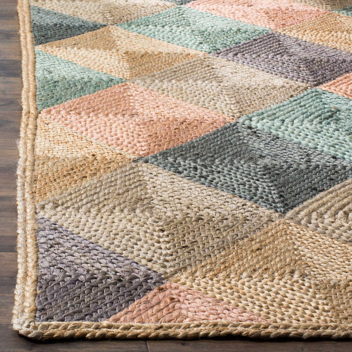 Bound jute edges frame tightly woven blocks of coral, aqua, sage, and natural tan.
