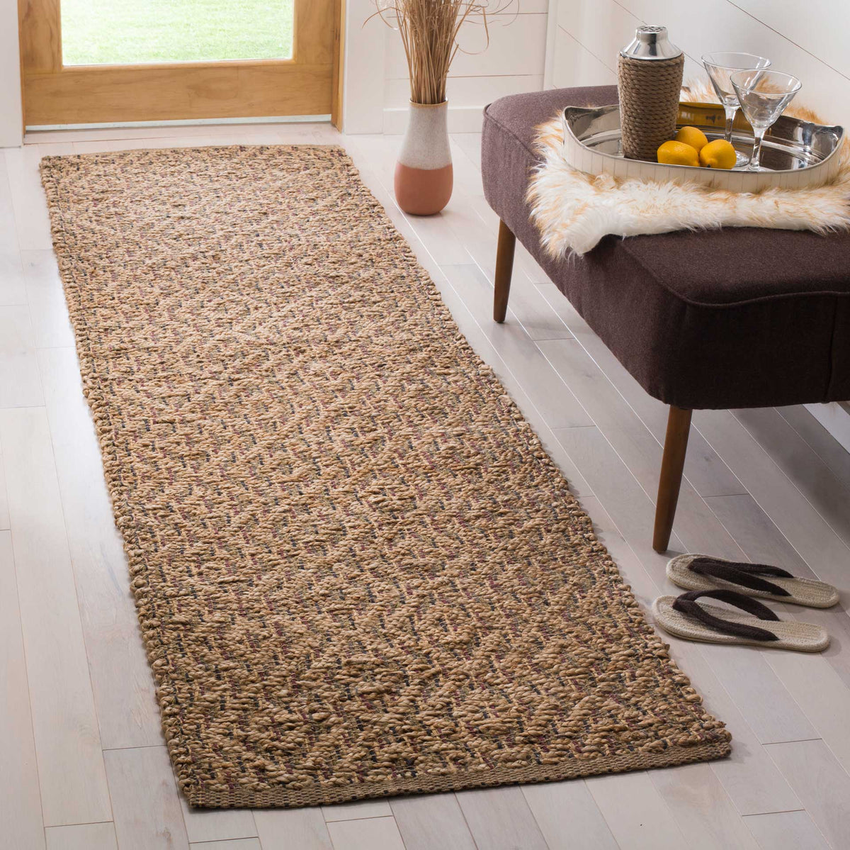 A finely mottled jute runner lends quiet color and earthy texture to a bright entryway.