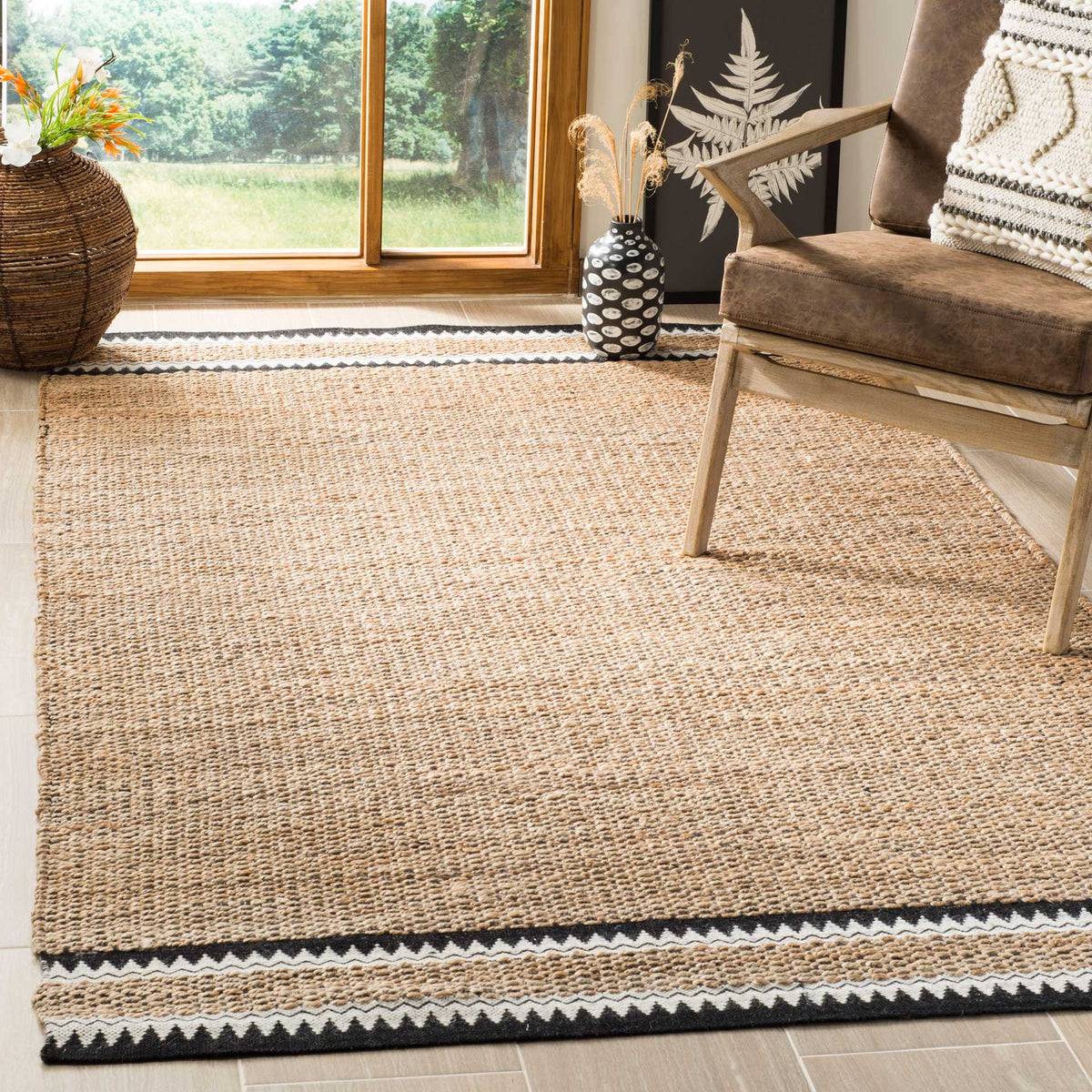 Earthy jute rug with black-and-ivory bands anchors a rustic upholstered chair.