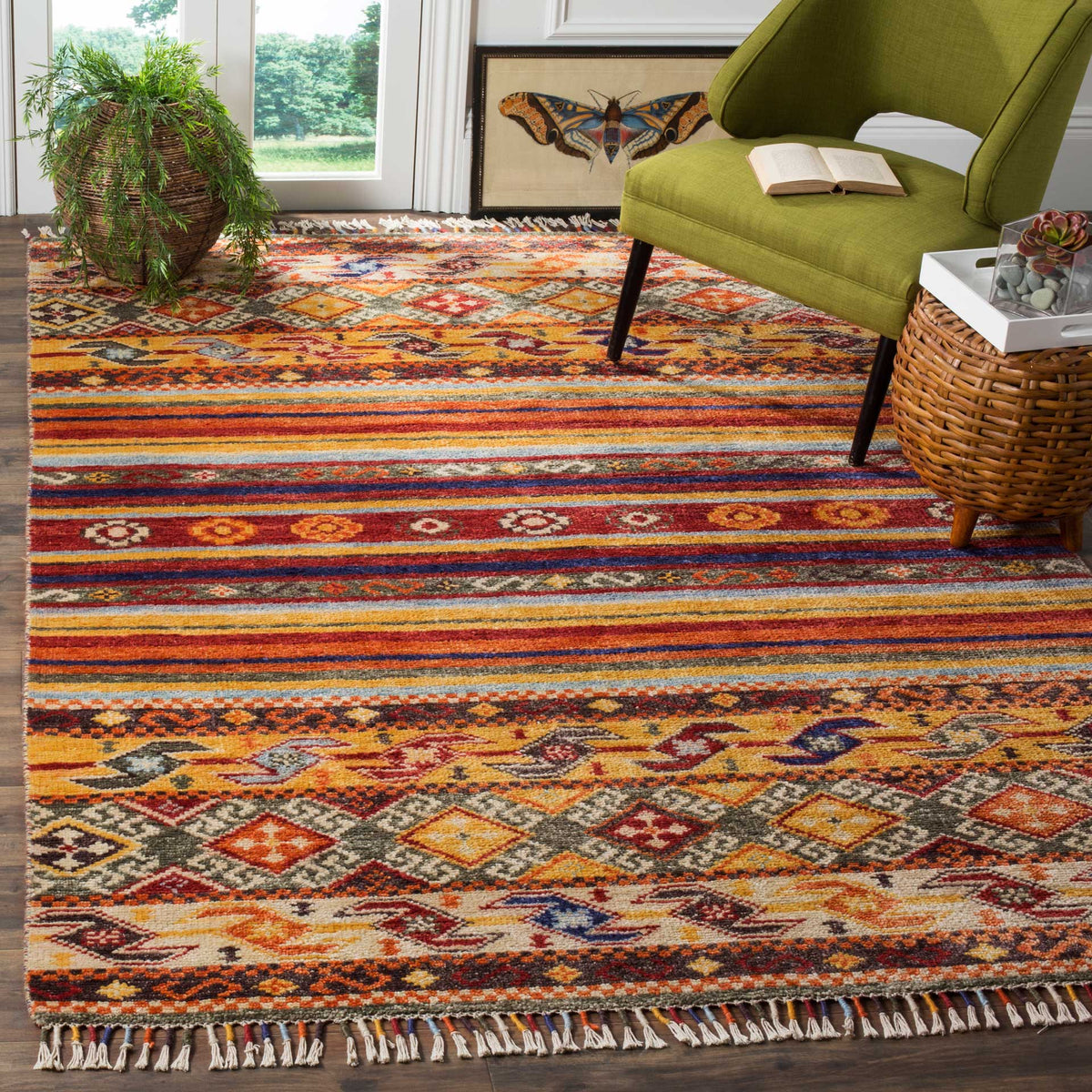 Bold stripes and geometric borders add warmth and color beneath an accent chair.