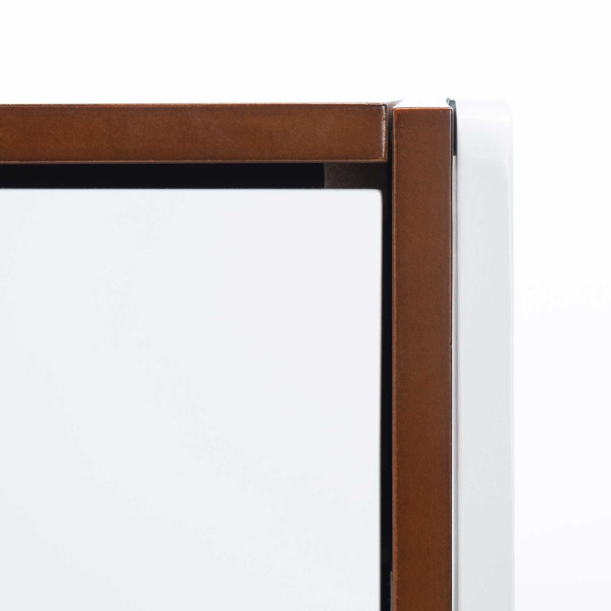 Rich walnut trim borders a smooth white drawer, highlighting the nightstand's clean lines.